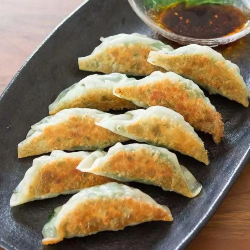 Pan-fried dumplings with crispy golden bottoms at New Tokyo Sushi, a Sushi Restaurant in Jamaica
